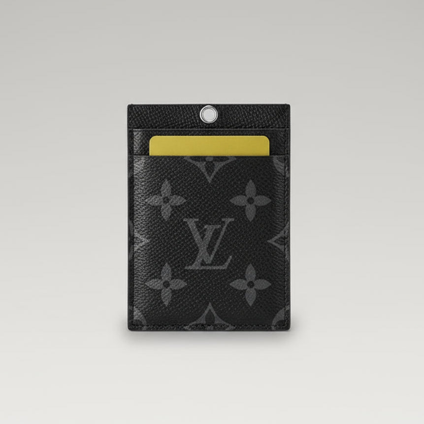Black cardholder with yellow card on a brown leather surface