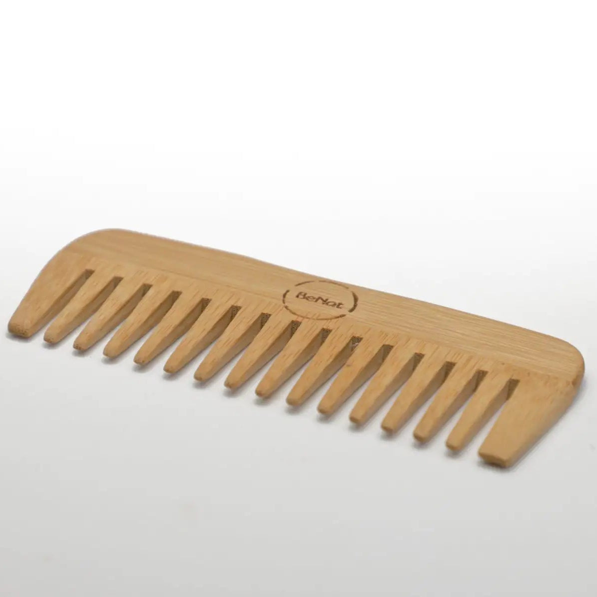 Wooden comb on a white background