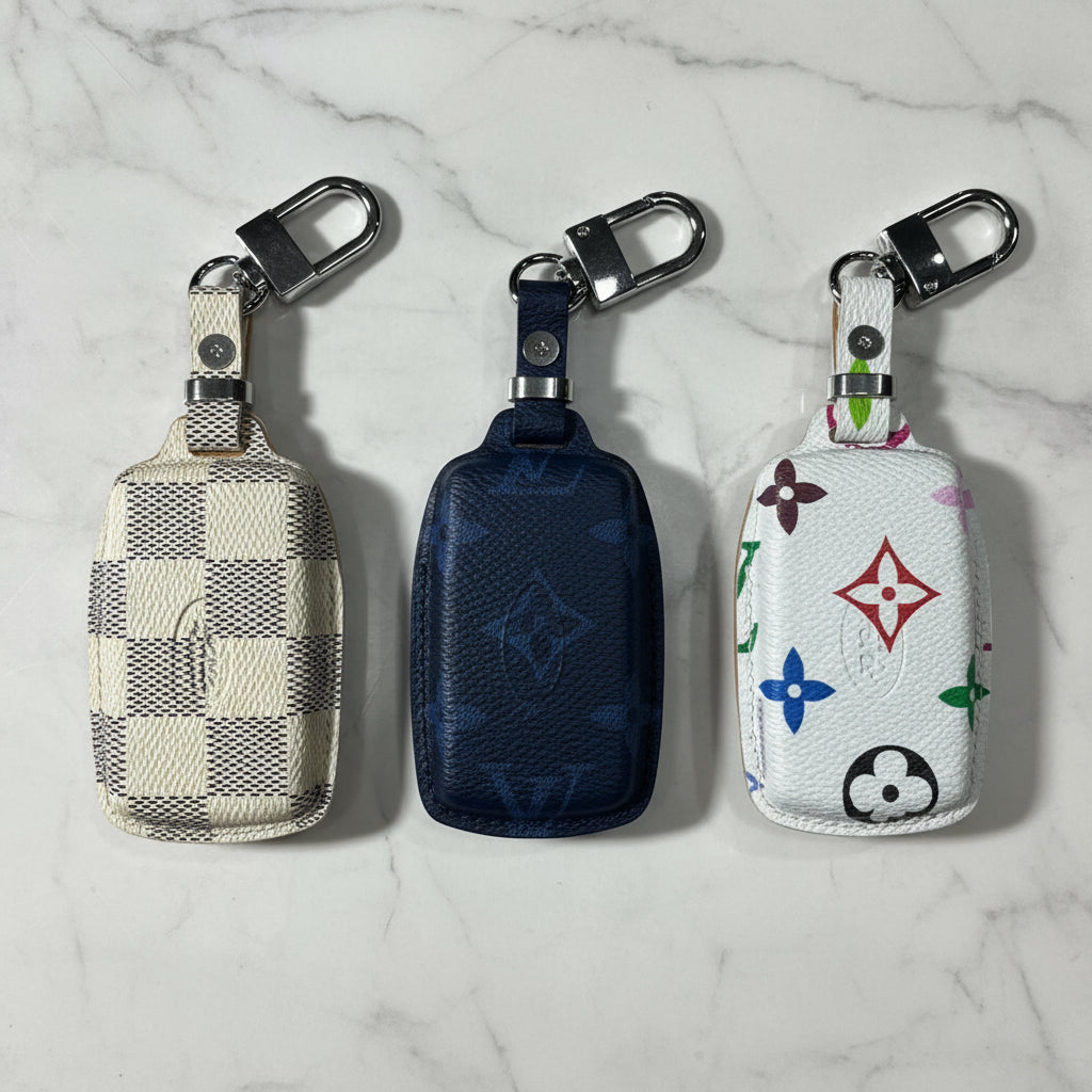 Three keychains with different designs on a marble surface