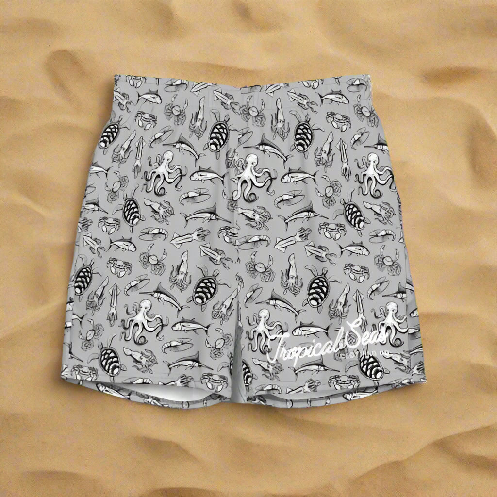 Gray shorts with black sea creature pattern on a wave background, featuring 'Tropical Seas' branding.
