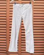 White jeans hanging on a wooden background