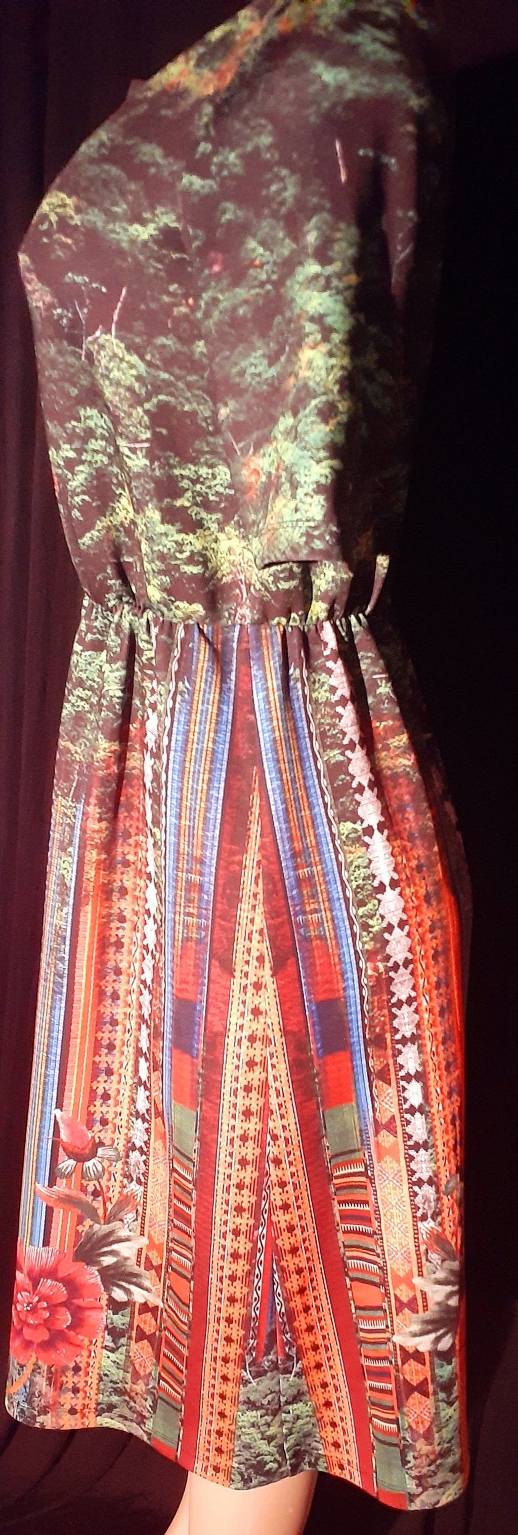 Multicolored patterned dress with a belt on a dark background