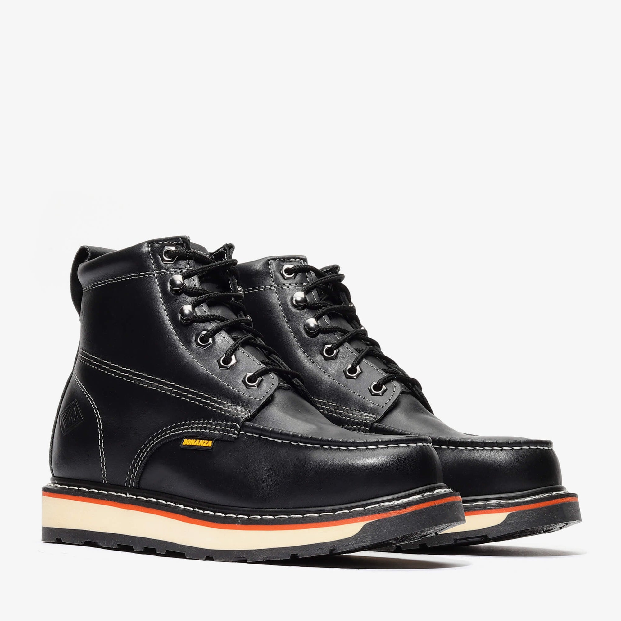 Pair of black leather boots with a white sole on a light gray background