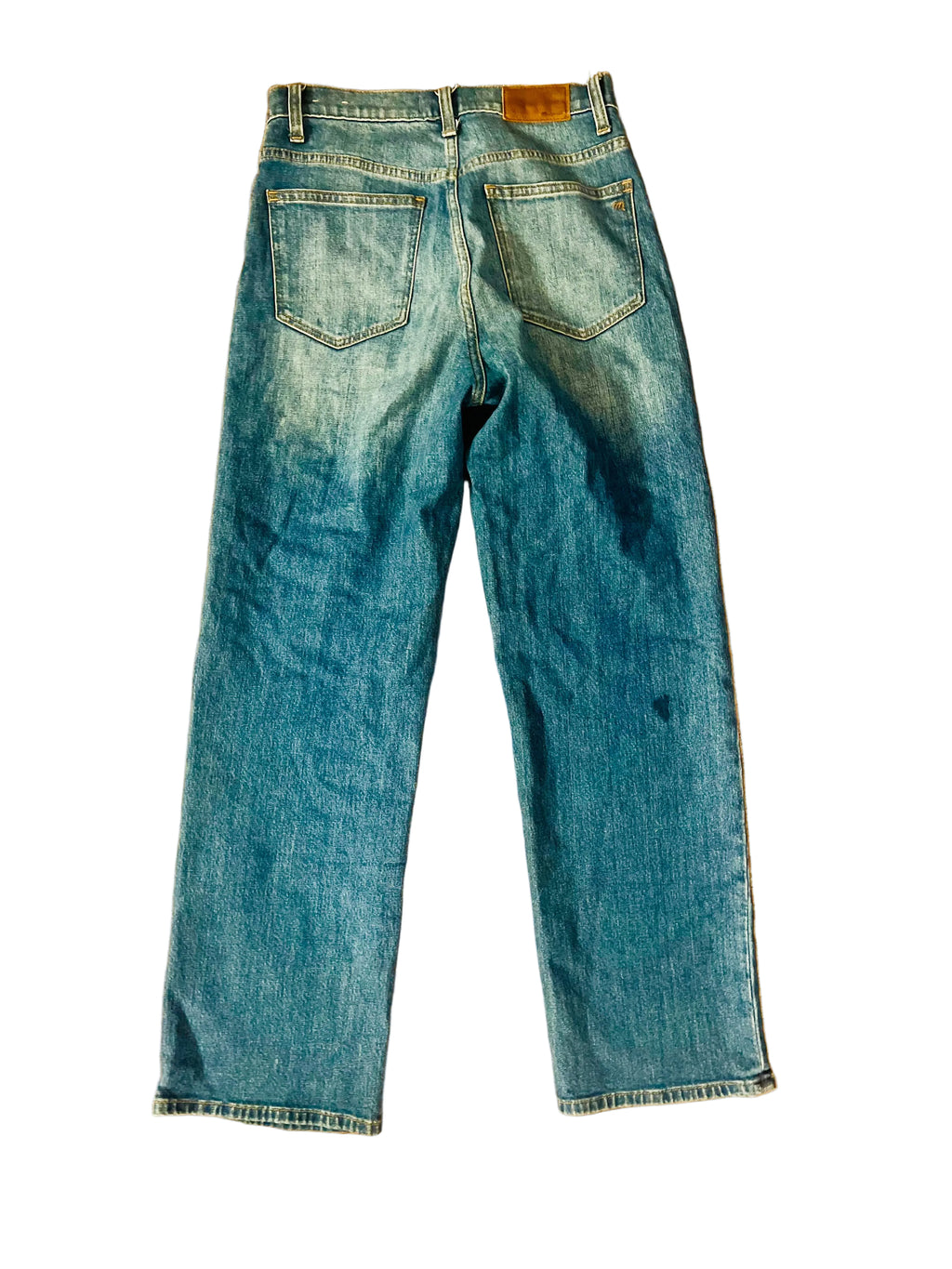 Blue jeans on a wooden floor