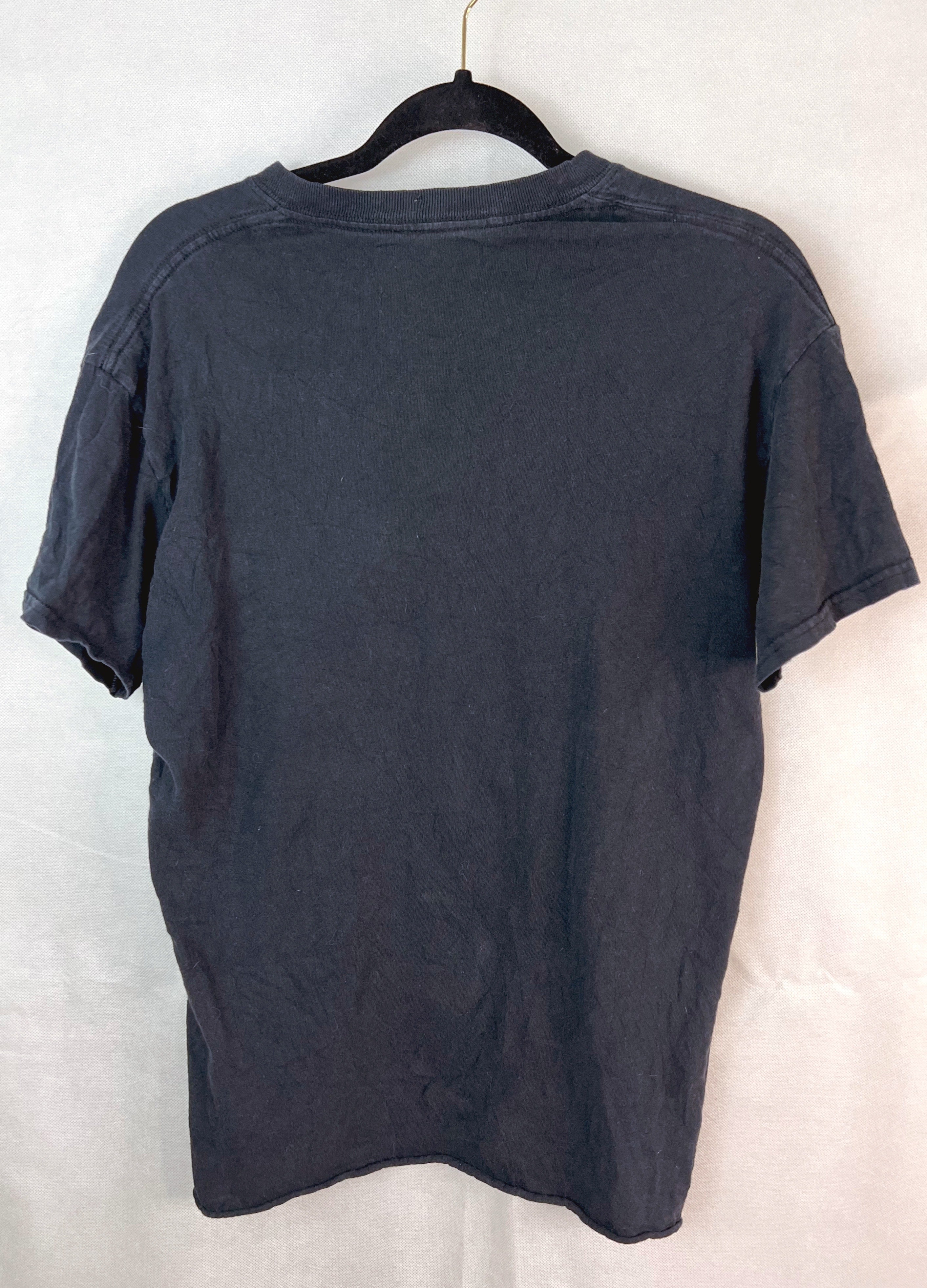 A dark charcoal gray short-sleeve t-shirt hanging on a black hanger against a white fabric backdrop.