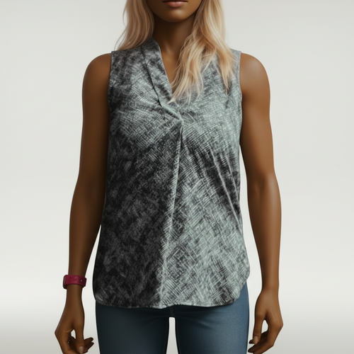 Woman wearing a patterned sleeveless top in a bright room with wooden shelves.
