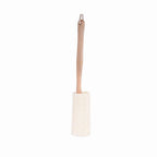Cleaning brush with wooden handle and white bristle head on a white background