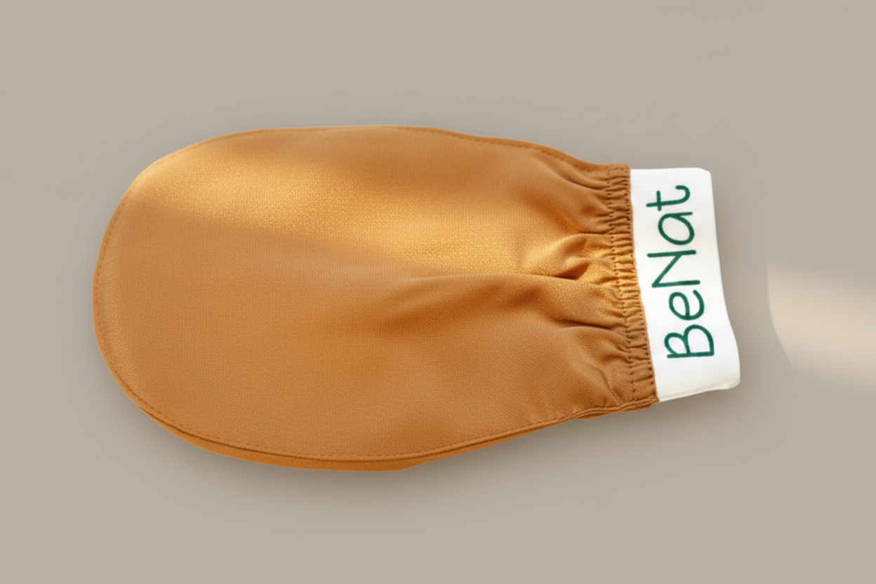 Beige exfoliating mitt with 'Benat' branding on a beige background