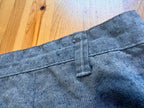 Close-up of blue denim fabric on a wooden surface