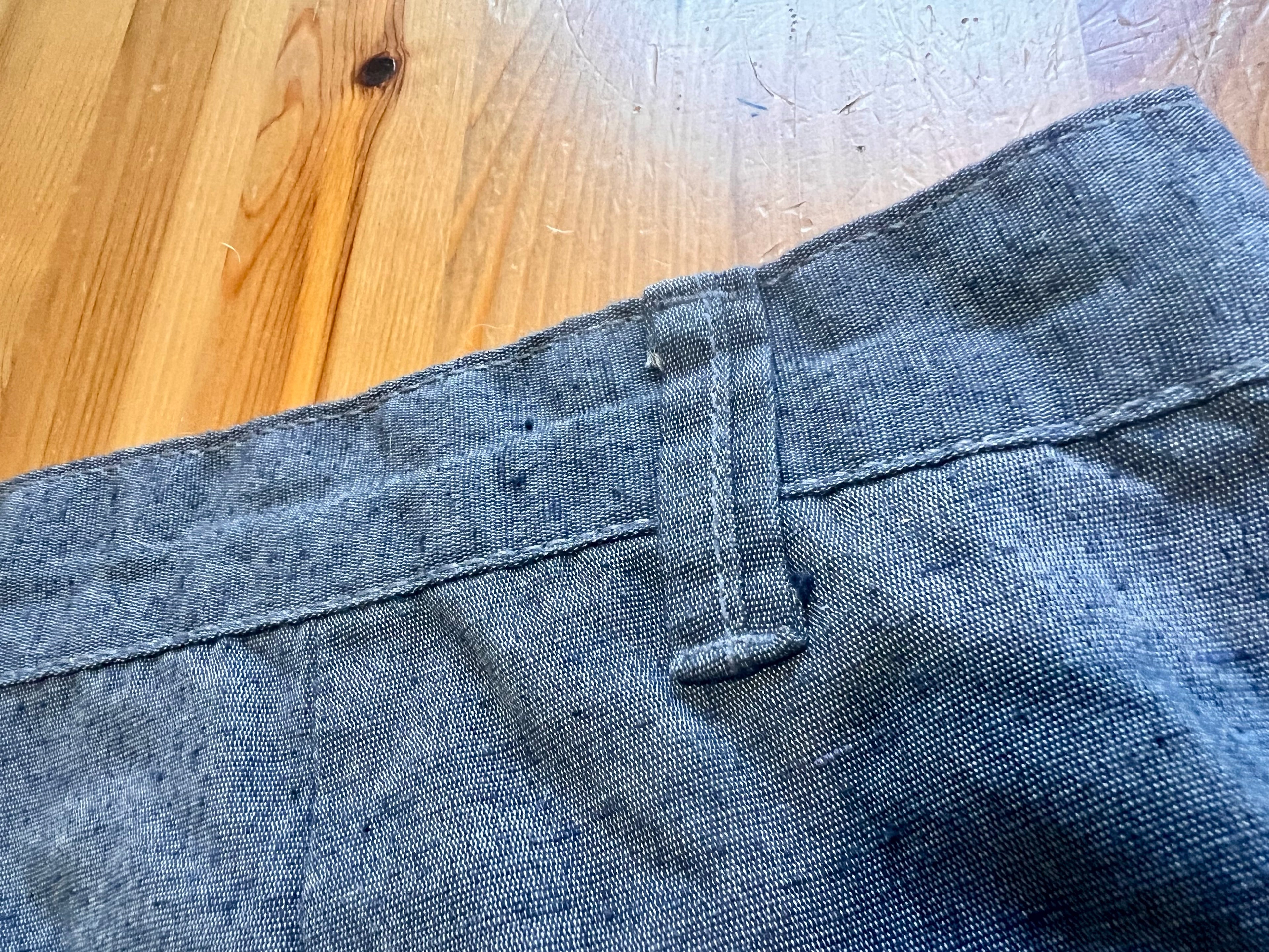Close-up of blue denim fabric on a wooden surface
