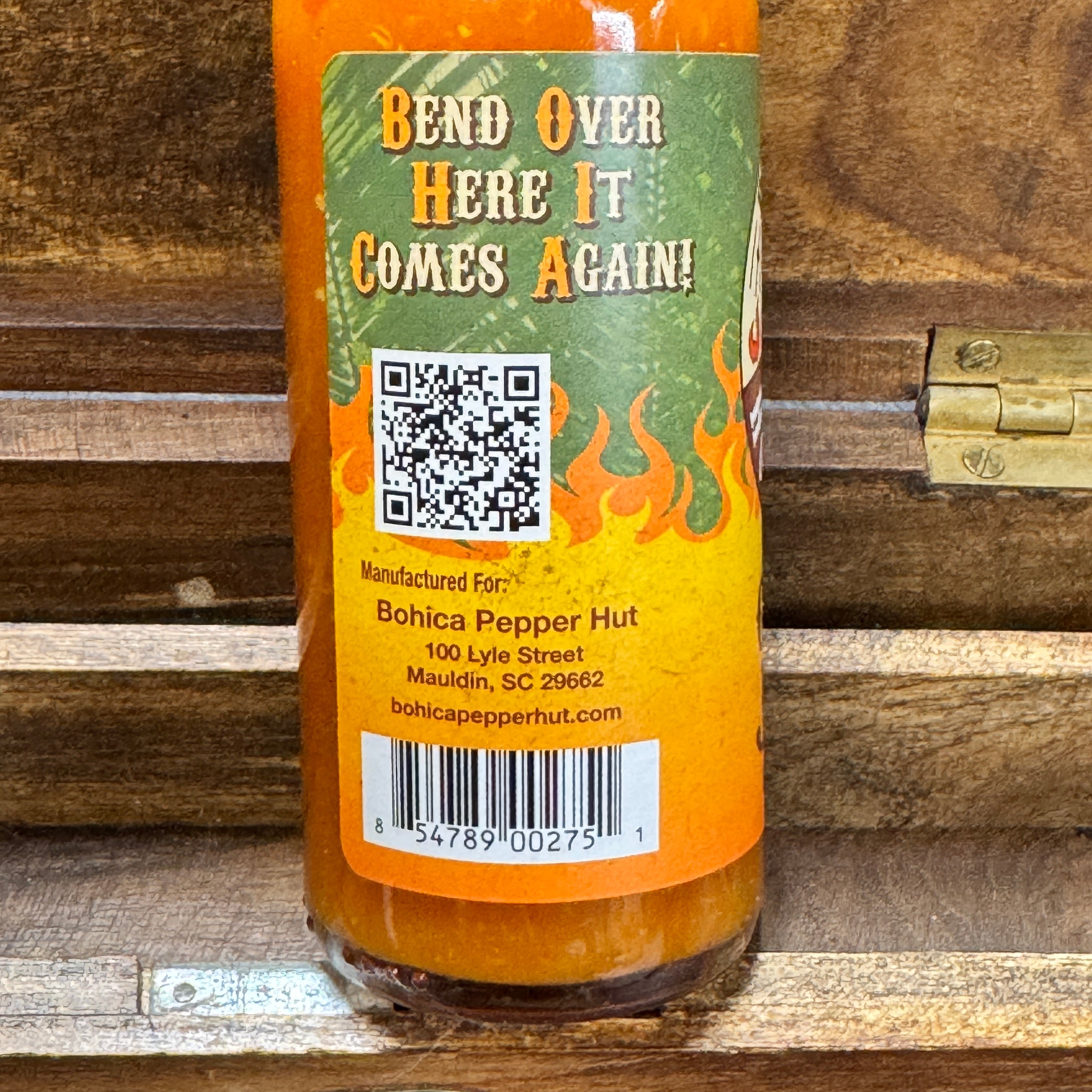 Hot sauce bottle with label on a wooden surface