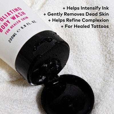 Body wash bottle with black cap on a white towel, featuring text about its benefits.
