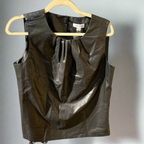 Black leather vest on a hanger against a neutral background