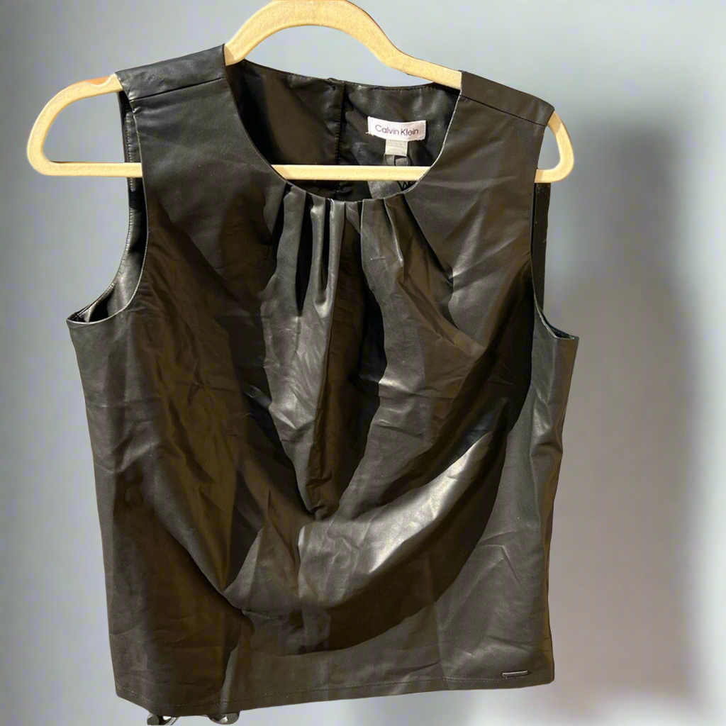 Black leather vest on a hanger against a neutral background