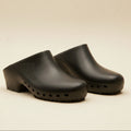 Pair of black clogs on a white background