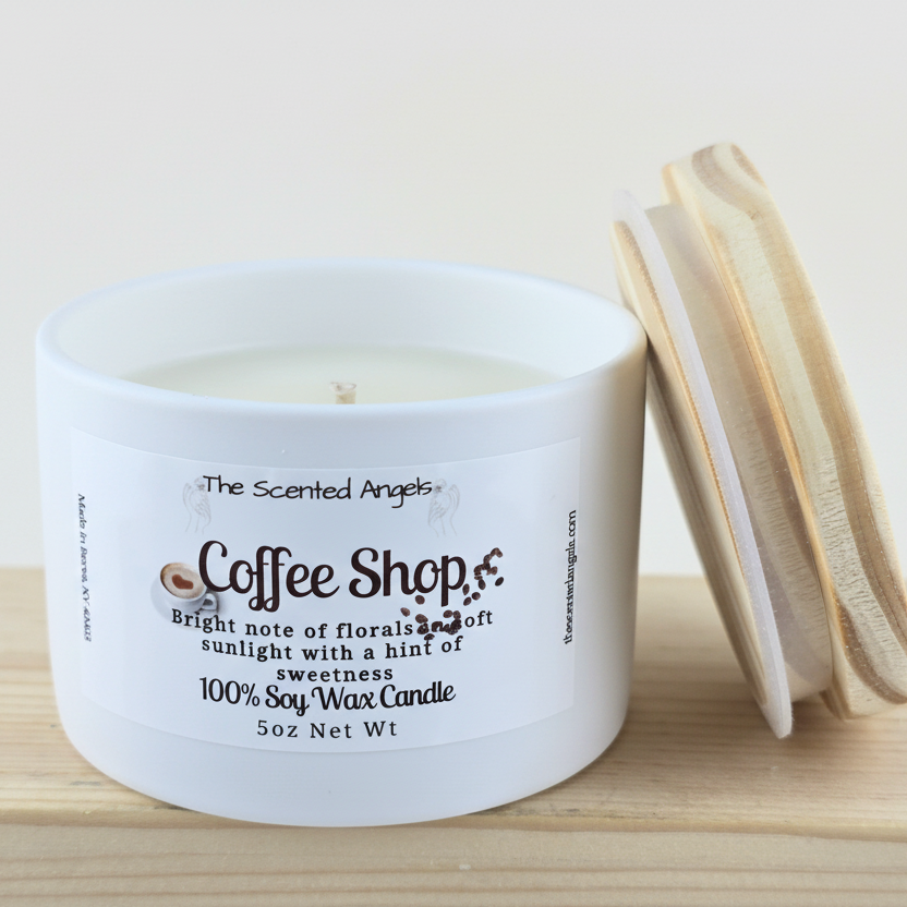 White candle labeled 'Coffee Shop' with wooden wick on a wooden surface