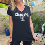 Person wearing a black 'Colorado' t-shirt outdoors