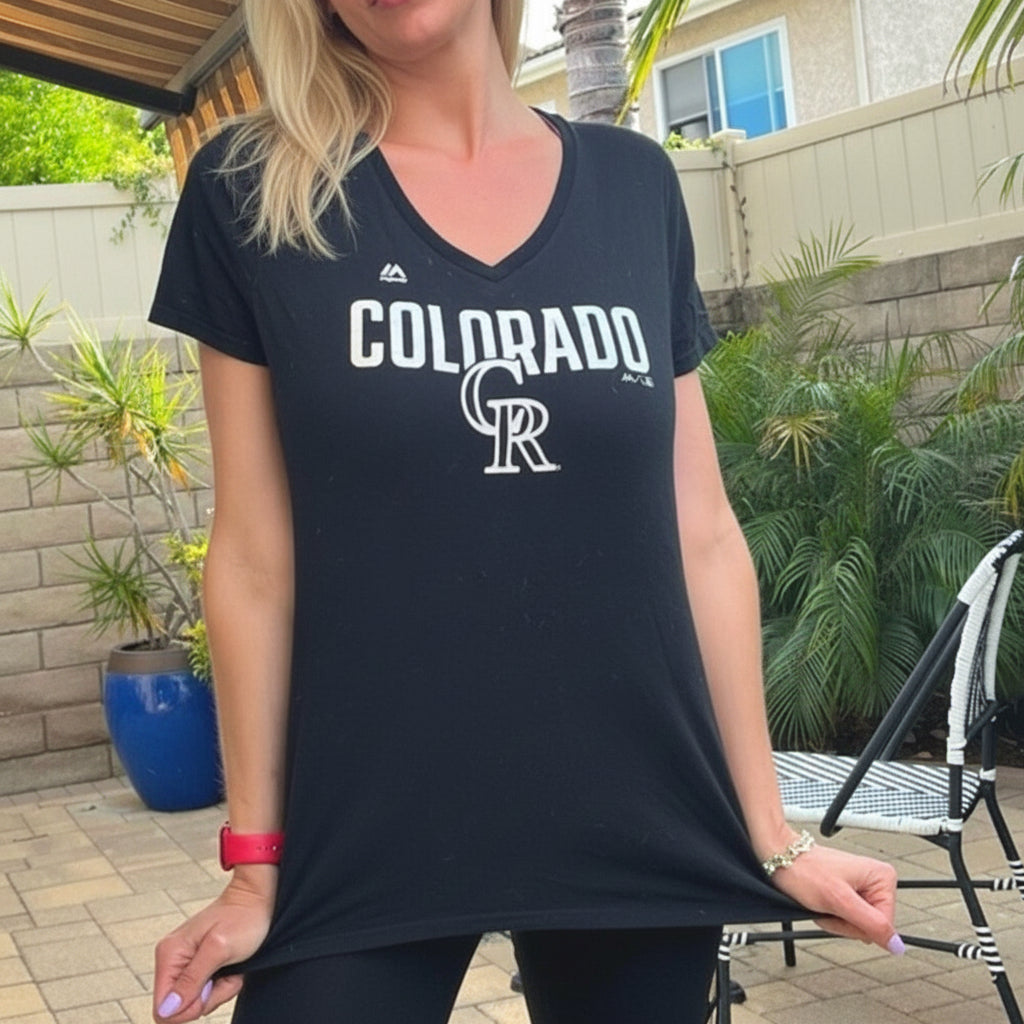 Person wearing a black 'Colorado' t-shirt outdoors