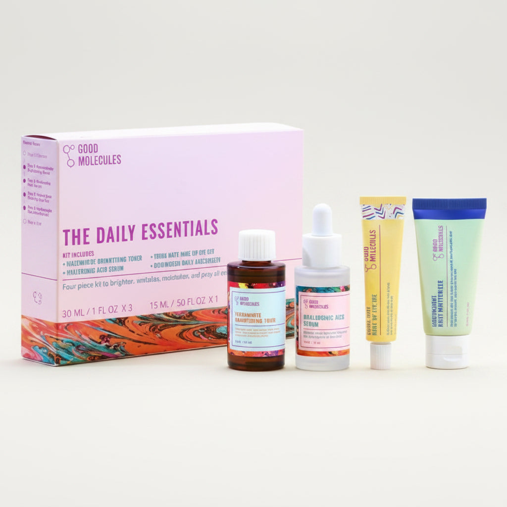 Collection of skincare products including a box labeled 'The Daily Essentials' on a light blue background.
