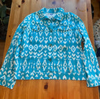 Blue and white patterned jacket on a wooden table
