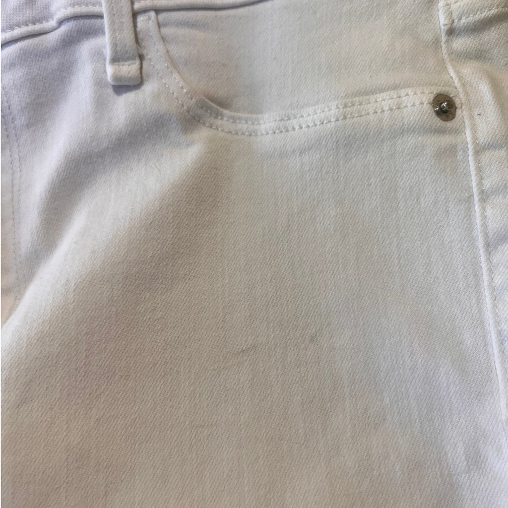Close-up of light-colored denim fabric with stitching details