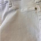 Close-up of light-colored denim fabric with stitching details
