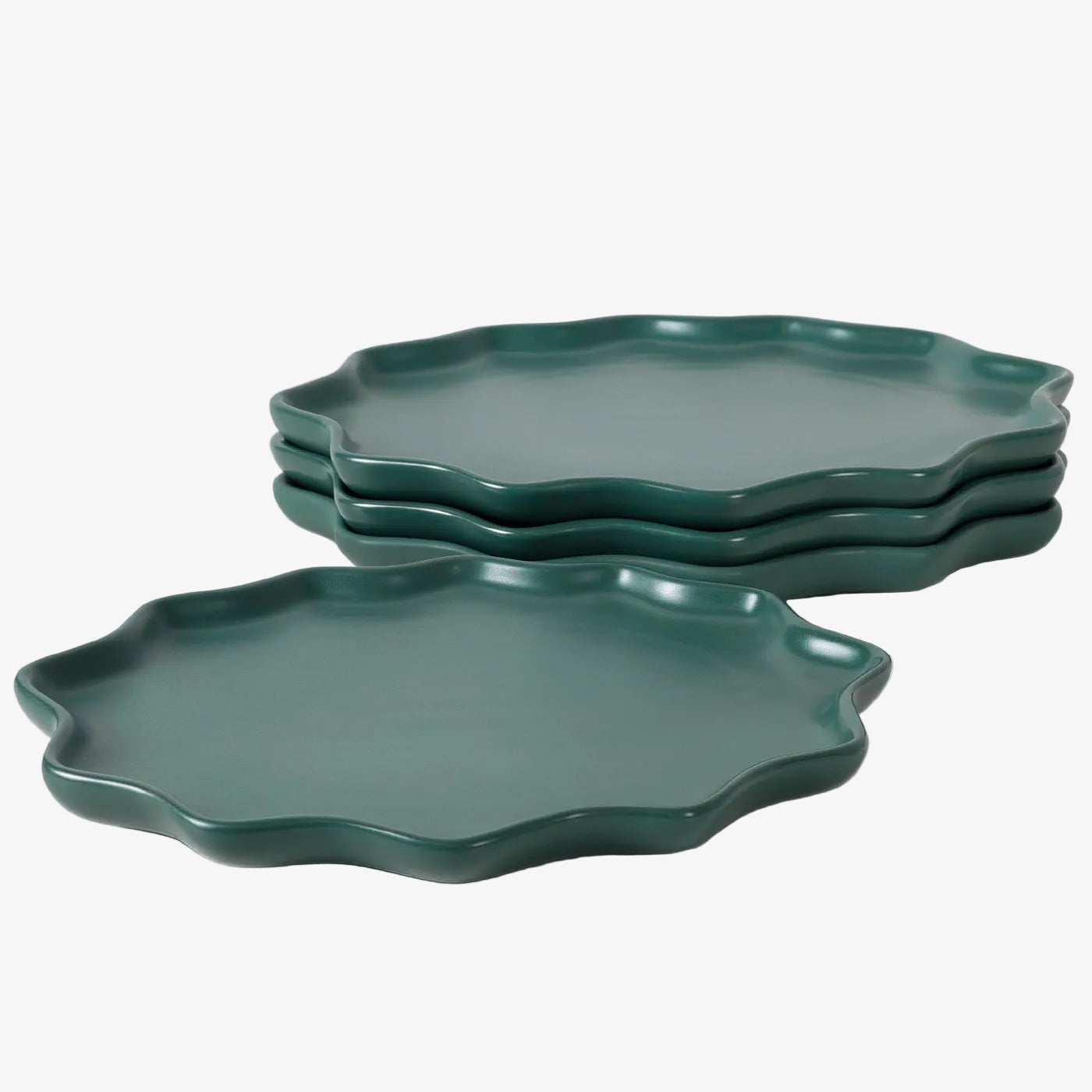 Set of green ceramic plates on a white background