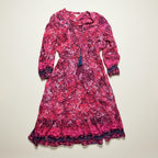 Pink floral dress with long sleeves on a white background