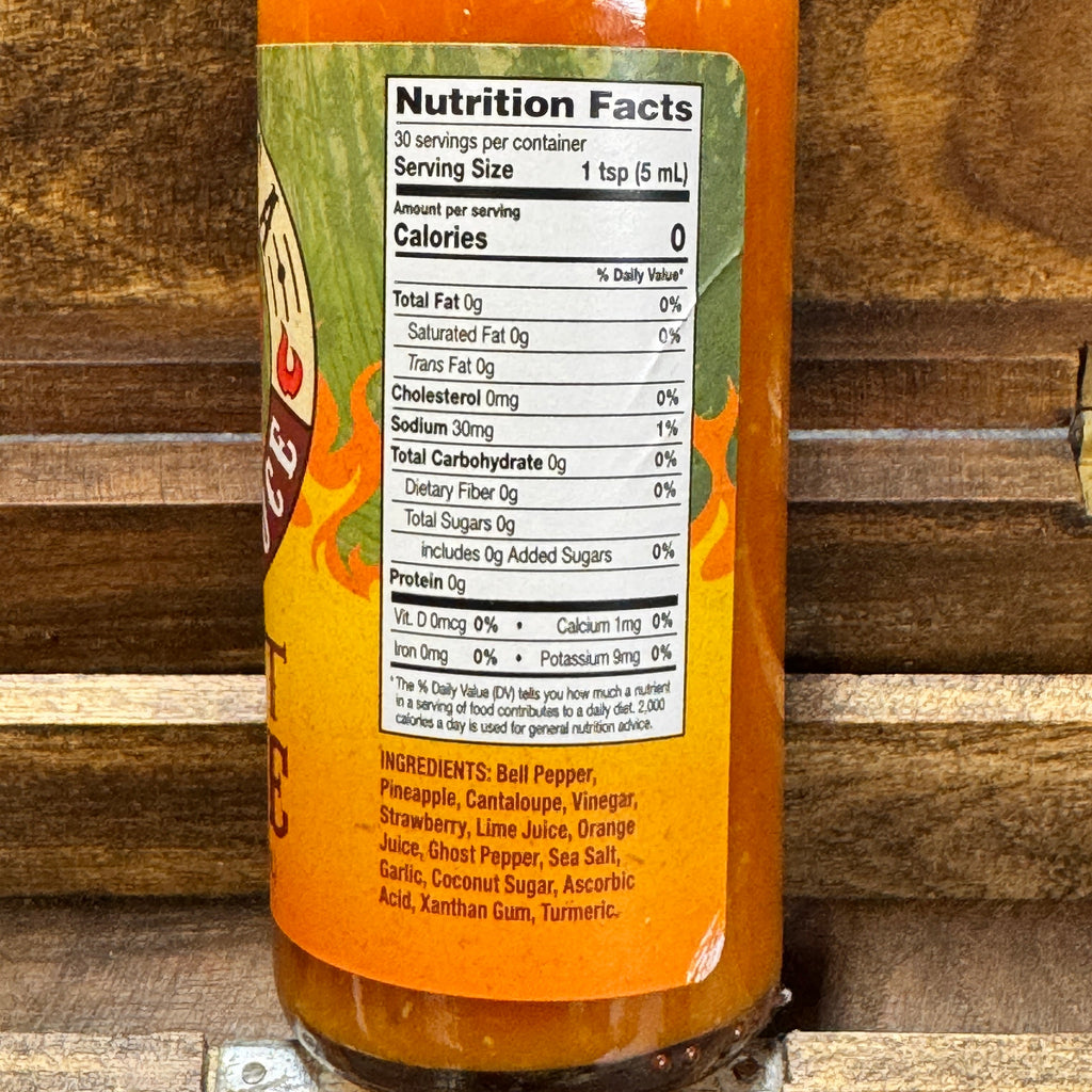 Sriracha bottle with nutrition facts label on a wooden background