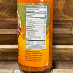 Sriracha bottle with nutrition facts label on a wooden background