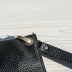 Close-up of a black leather wristlet