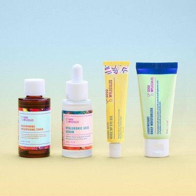 Set of skincare products including bottles and tubes on a gradient background