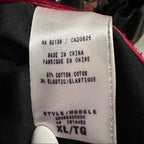Fabric tag on clothing with text indicating 'Made in China' and material composition.