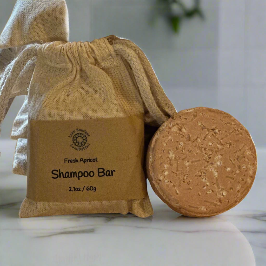 Shampoo bar in a brown drawstring bag with visible branding on a white background