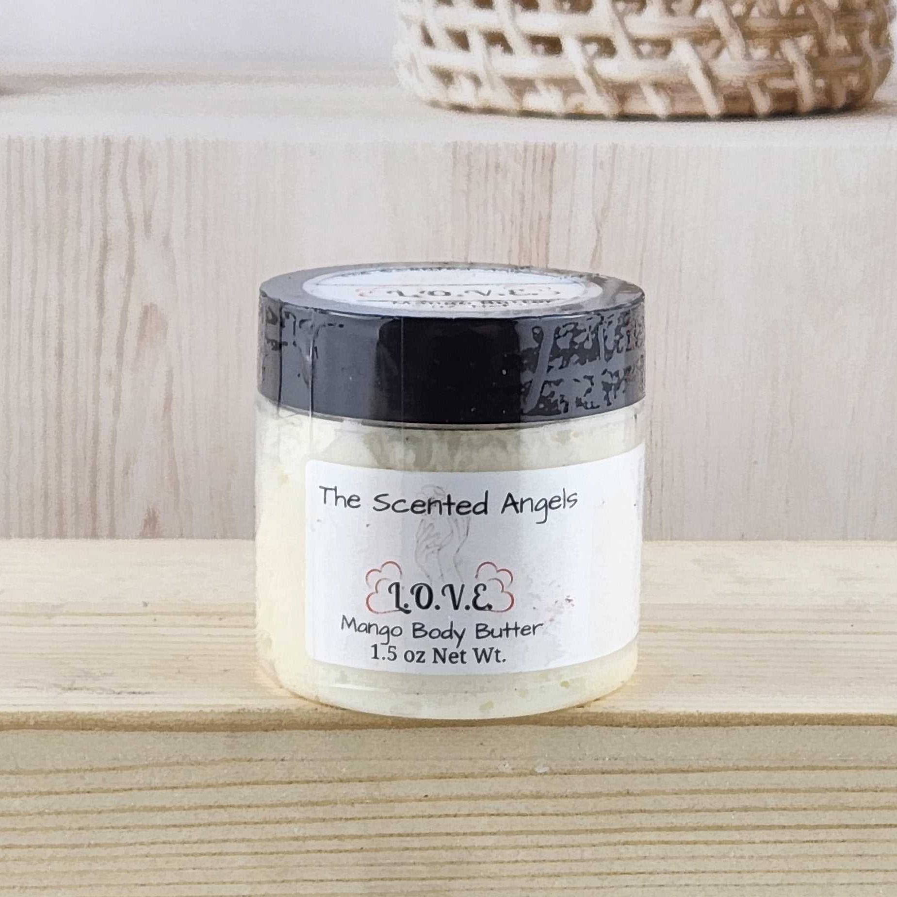 Jar of body butter on a wooden surface with a neutral background