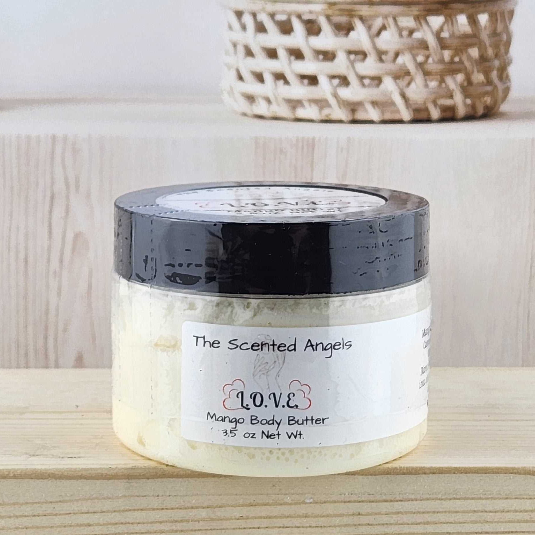 Jar of body butter on a wooden surface with a neutral background