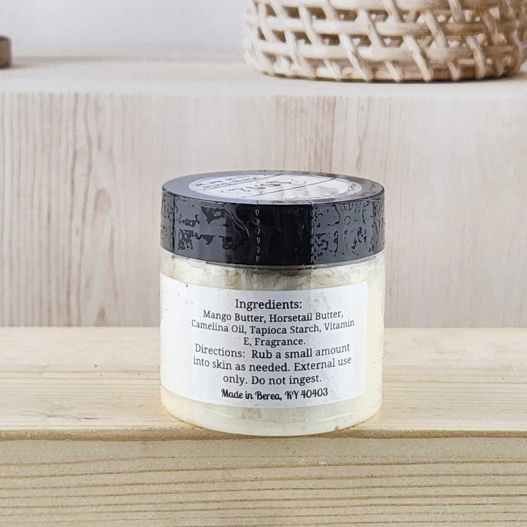 Jar of cream on a wooden surface with a neutral background