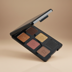 Makeup palette with six different shades on a beige background