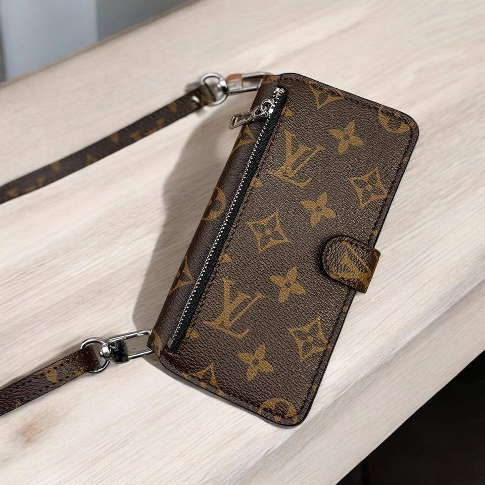 Designer wallet with monogram pattern on a light wooden surface