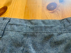 Close-up of blue denim fabric on a wooden surface