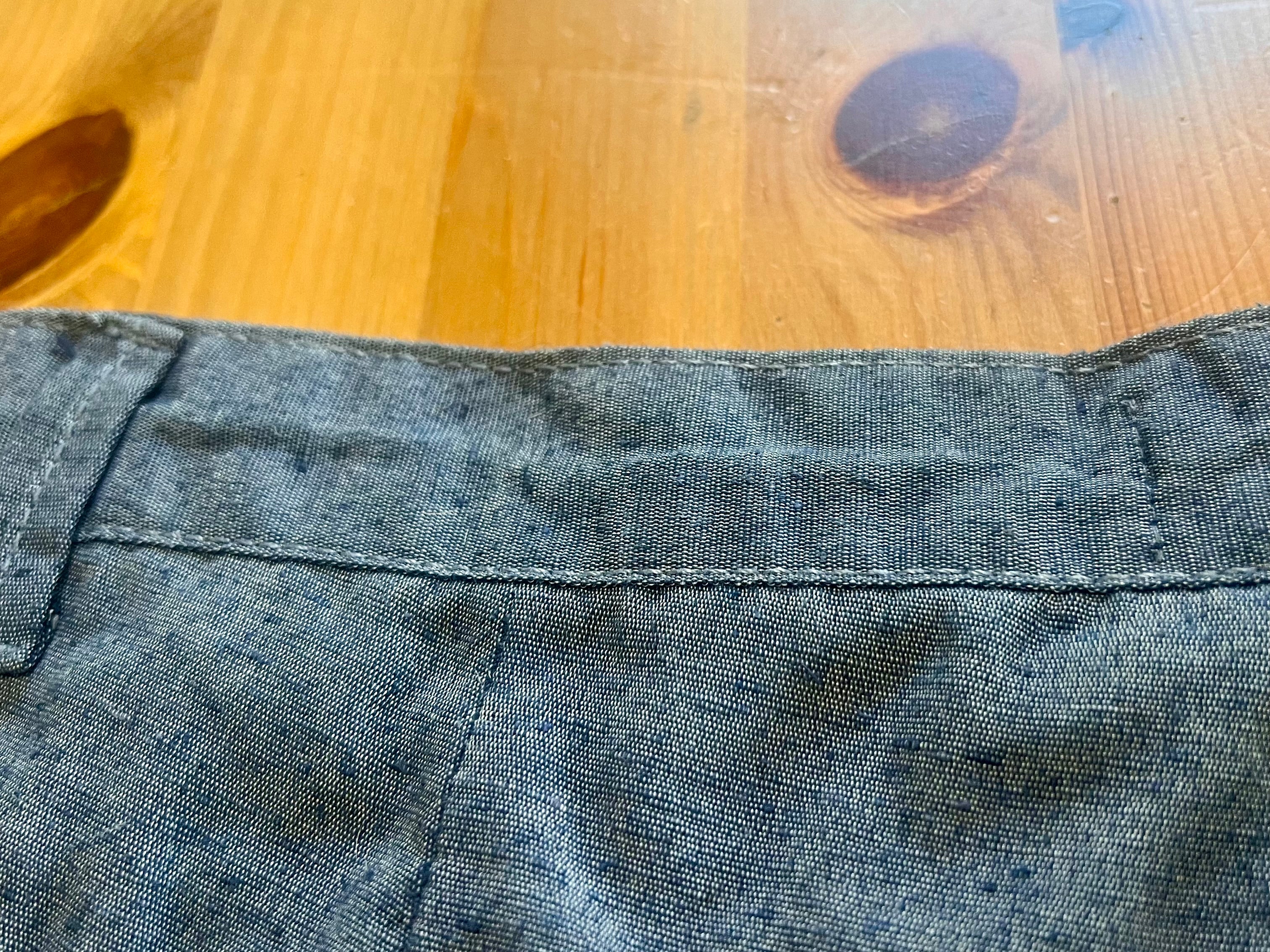Close-up of blue denim fabric on a wooden surface