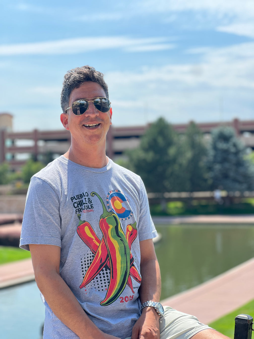 Man wearing a gray t-shirt with chili pepper design outdoors