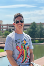 Man wearing a gray t-shirt with chili pepper design outdoors