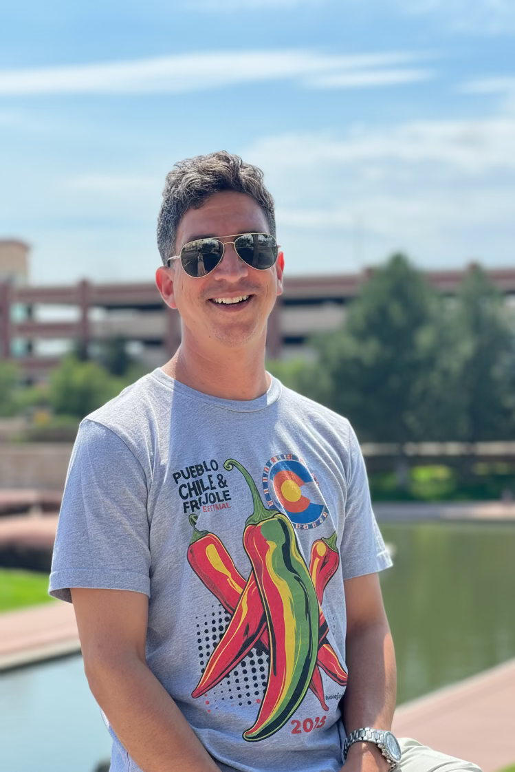 Man wearing a gray t-shirt with chili pepper design outdoors