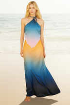 Woman wearing a colorful gradient dress on a beach