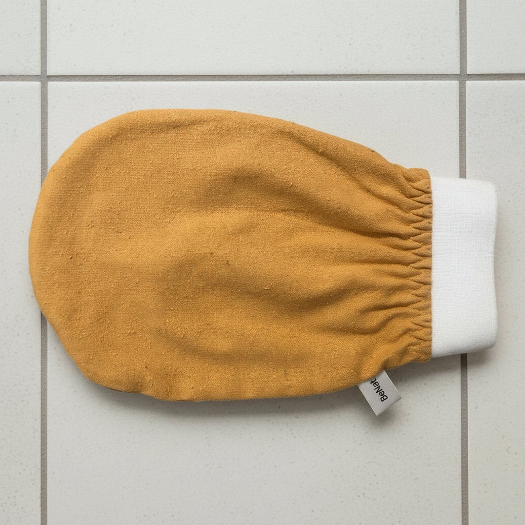 Yellow baby mitt with white cuff on a white background