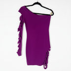 Purple one-shoulder dress with ruffled details on a hanger against a white background