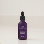 Purple serum bottle with dropper labeled 'Oyu Botanica' on a light background