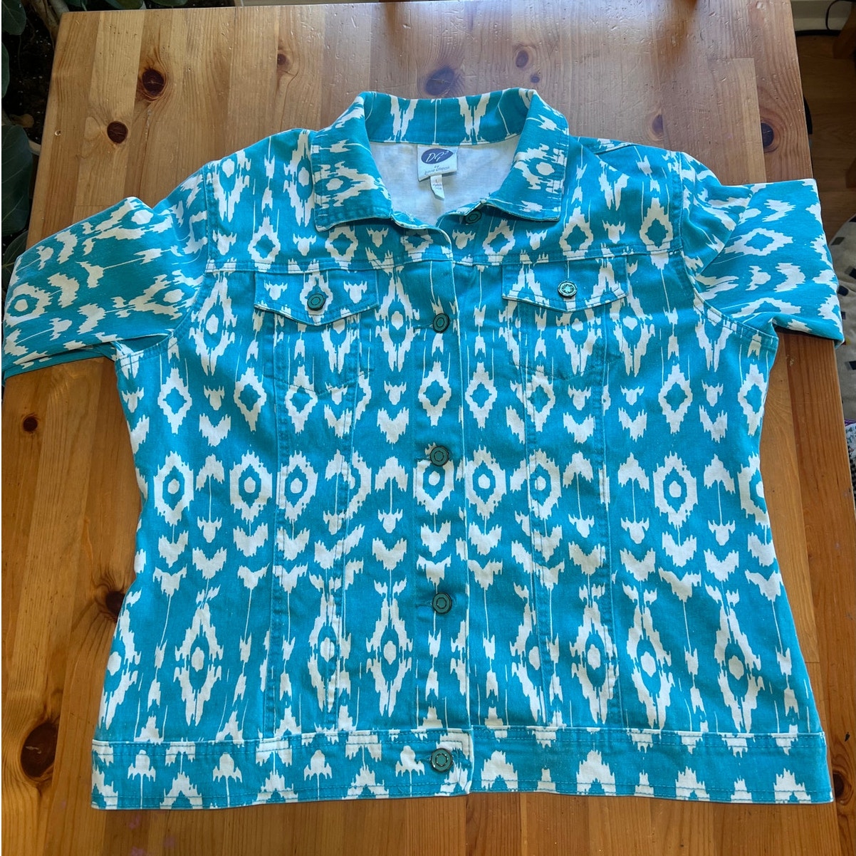 Blue and white patterned jacket on a wooden surface