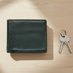 Green leather wallet on a marble surface with green leaves